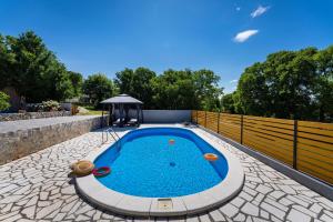 a swimming pool in the middle of a backyard at My Dalmatia - Villa Manda Adriatic with Private Heated Pool in Skradin +52 photos