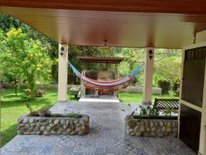 a hammock on the back of a porch at Cabaña Kundalini in Antón +18 photos