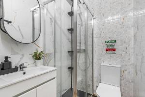 a bathroom with a shower and a toilet and a sink at Bom Braga AL in Braga +35 photos