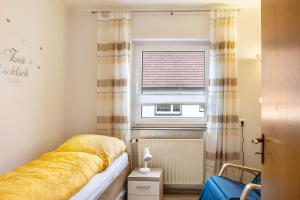 a bedroom with a bed and a window at Ferienwohnung Franni in Wabern