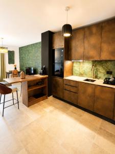 a kitchen with wooden cabinets and a table and a chair at Superbe Appartement - Centre Calvi - Parking privé in Calvi +26 photos