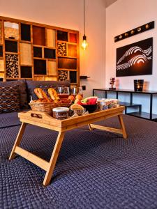a coffee table with a tray of food on it at Le Lovy , Studio indépendant avec Jacuzzi in Cézac