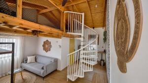 a living room with a staircase and a couch at צימרים Jordan River Village in Menaẖemya +45 photos