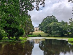 a view of a river with a building in the background at Hilston Gate House in Skenfrith
