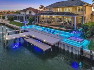an aerial view of a house with a dock in the water at Waterfront home with pool, spa and 2nd floor balcony in Marco Island