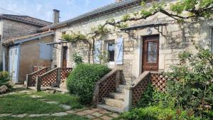 a stone house with stairs and a wooden door at Maison de Pierre in Septfonds