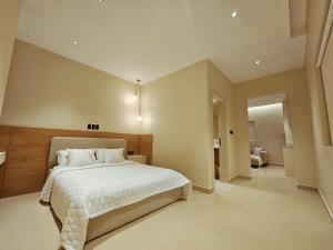 a bedroom with a large bed in a room at شقق عبادي مميزه 1 in Dammam