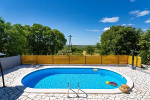 a large swimming pool in a yard with a fence at My Dalmatia - Villa Manda Adriatic with Private Heated Pool in Skradin