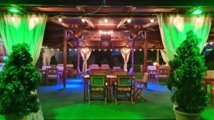 a set up for a party with tables and chairs at GARDEN Club - Hotel & Restaurant - FREE Outdoor Pool & Parking in Braşov +59 photos
