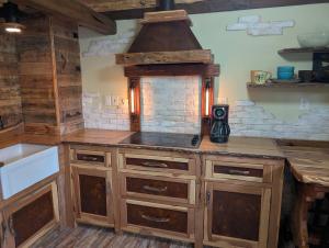 a kitchen with wooden cabinets and a stove top oven at Lazy Bull Cottages in Bull Shoals +49 photos