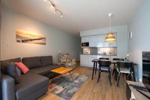 a living room and kitchen with a couch and a table at Apartament u Jadwigi in Jantar