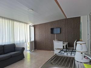 a living room with a couch and a stove at Hotel Antonio in Çeşme