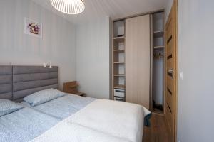 a bedroom with a bed and a closet at Apartament u Jadwigi in Jantar