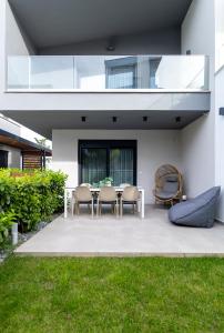 a patio with a table and chairs in a house at Diamond Gold Suite in Iraklitsa