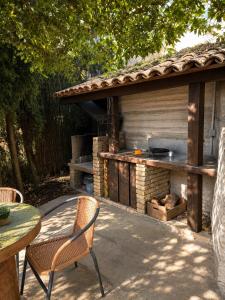 a patio with a grill and a table and chairs at Torre Viladot in Solsona