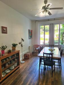 a dining room with a table and chairs and a ceiling fan at Les Gites du 74 R Le Classique in Senones