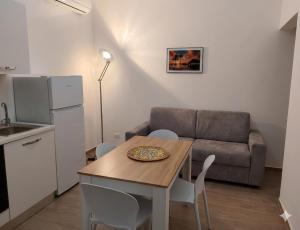 a living room with a table and a couch at Casa Aurora & Santiago in Trapani