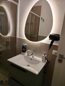 a bathroom with a sink and a mirror at Casa Aurora & Santiago in Trapani