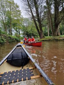 a group of people in a boat on a river at Hilston Gate House in Skenfrith +4 photos