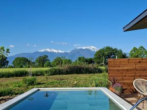 a swimming pool with a chair and mountains in the background at Olympus Pool Retreat in Katerini