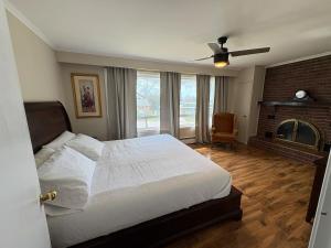 a bedroom with a large bed and a fireplace at Spacious Cottage Style Home in Toronto