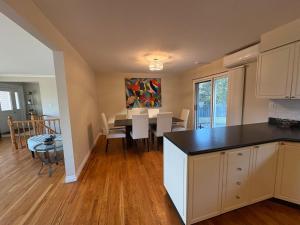 a kitchen and living room with a table and a dining room at Spacious Cottage Style Home in Toronto