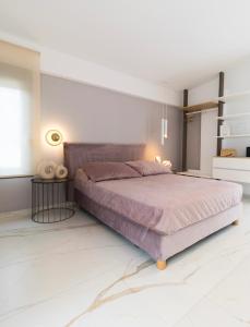 a bedroom with a large bed in a white room at Diamond Gold Suite in Iraklitsa