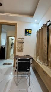 a room with a table and a chair in it at Healer home in Rishīkesh