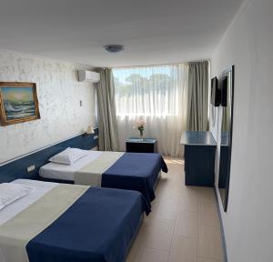 a hotel room with two beds and a window at Hotel Venus in Venus +23 photos