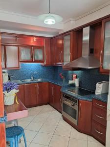 a kitchen with wooden cabinets and a stove top oven at The Spartan Horizon in Sparta