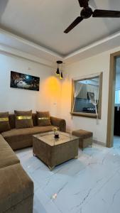 a living room with a couch and a coffee table at Healer home in Rishīkesh