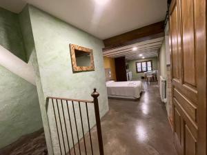 a bedroom with a bed and a staircase in a room at Casa O'Tinte in Alquézar