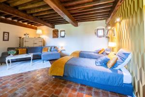 a bedroom with two beds and a living room at Château beyrin in Traize +59 photos