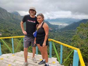 a man and a woman standing on top of a mountain at Greentea Hostel in Labuhanhaji