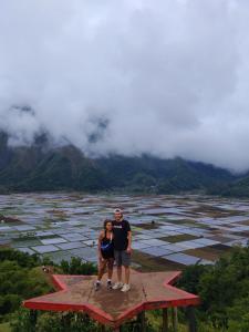 a man and a woman standing on top of a star at Greentea Hostel in Labuhanhaji
