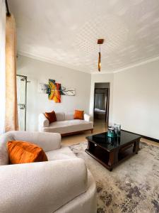 a living room with a couch and a coffee table at Happy homes stay in Namugongo