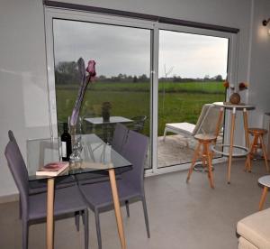 a dining room with a table and chairs and a window at Olympus Pool Retreat in Katerini