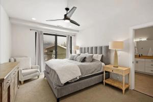 a bedroom with a bed and a chair and a window at Cozy Luxury in Big Sky in Big Sky