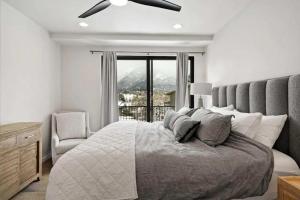 a bedroom with a bed with a chair and a window at Cozy Luxury in Big Sky in Big Sky