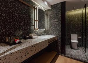 a bathroom with a sink and a toilet at VOS Suites By BOLD in Gelugor +5 photos