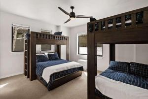 a bedroom with two bunk beds and a ceiling fan at Cozy Luxury in Big Sky in Big Sky