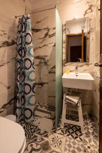 a bathroom with a sink and a toilet and a shower at Marea Blue Seaview Apartments of Santa Barbara in Marathias +33 photos