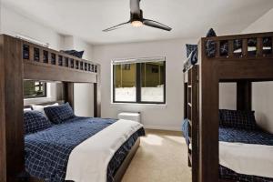 a bedroom with two bunk beds and a ceiling fan at Cozy Luxury in Big Sky in Big Sky +2 photos