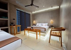 a hotel room with a bed and a table at Cavendish Polhena in Matara