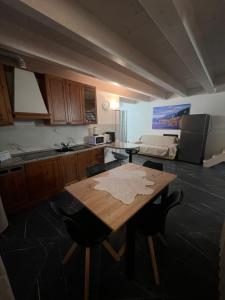 a kitchen with a wooden table and some chairs at Casa Gloria in Zelbio