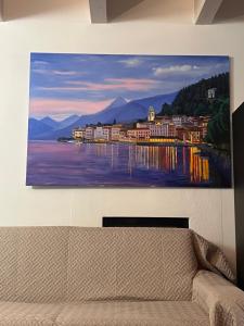 a painting hanging on a wall above a couch at Casa Gloria in Zelbio