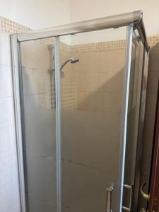 a shower with a glass door in a bathroom at Illumina House 2 in Giurdignano +13 photos