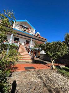a white house with stairs and a porch at O Cantinho do Pargo in Ponta do Pargo +9 photos