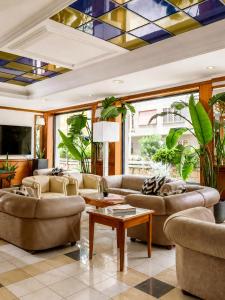 a living room with couches and a stained glass ceiling at Grand Hotel Tiberio in Rome