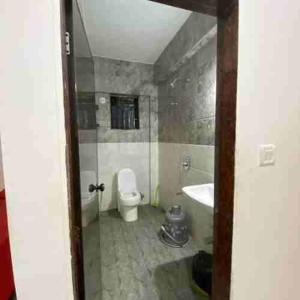 a bathroom with a toilet and a tub and a sink at Prakash Holiday Inn in Arambol